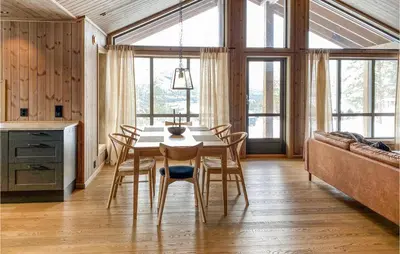 a dining room with a table and chairs and a couch at Cozy Home In Bjorli With Wifi in Bjorli