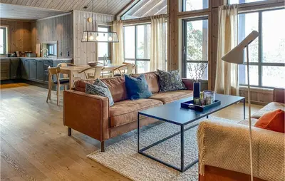 a living room with a couch and a table at Cozy Home In Bjorli With Wifi in Bjorli