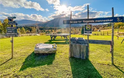 a park with a picnic table and street signs at Cozy Home In Bjorli With Wifi in Bjorli