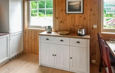 a kitchen with white cabinets and a counter at 2 Bedroom Stunning Home In Foldfjorden in Skogli