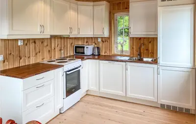 a white kitchen with white cabinets and a sink at 2 Bedroom Stunning Home In Foldfjorden in Skogli