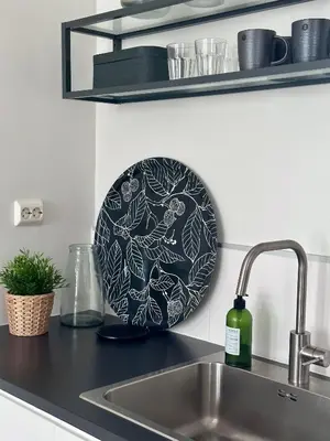 a plate sitting on a kitchen counter next to a sink at Stunning penthouse in the city! in Ålesund