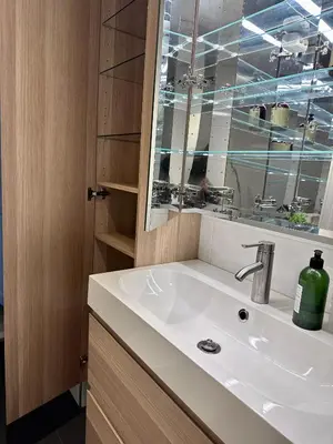 a bathroom with a sink and a mirror at Stunning penthouse in the city! in Ålesund