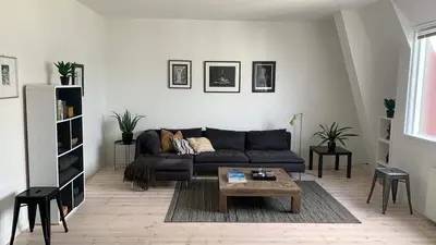 a living room with a couch and a coffee table at Stunning penthouse in the city! in Ålesund