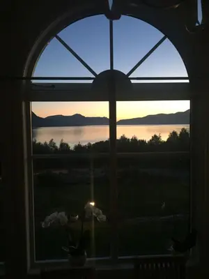 an open window with a view of a sunset at Sivert´s kontorhotell in Tomrefjord