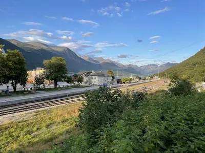 a view of a train station with mountains in the background at Villa i Isfjorden! in Isfjorden