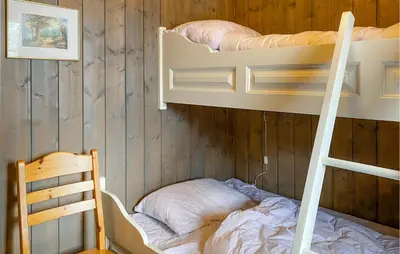 a bedroom with two bunk beds and a ladder at 3 Bedroom Nice Home In Bjorli in Bjorli
