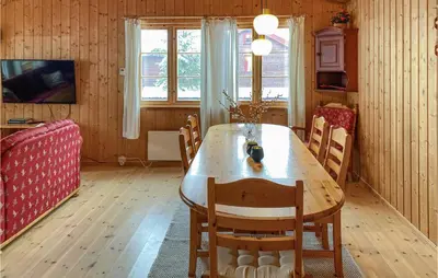 a dining room with a wooden table and chairs at 3 Bedroom Nice Home In Bjorli in Bjorli