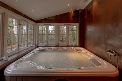 a jacuzzi tub in a room with windows at Chalet De Luxe 518 in Trysil