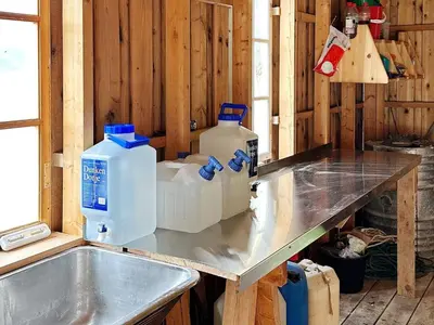 a kitchen with a counter with two gallons of water at 10 person holiday home in Snillfjord-By Traum in Snillfjord