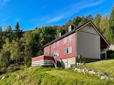 a red barn sitting on top of a hill at 10 person holiday home in Snillfjord-By Traum in Snillfjord