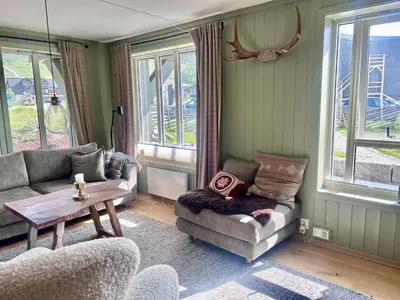 a living room with two couches and a table at Mailatunet - Vestlia resort in Geilo