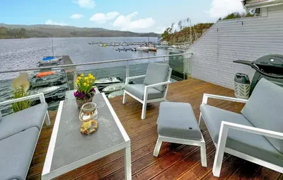 a deck with chairs and a table on a boat at Cozy Apartment In Uggdal With Wifi in Uggdal
