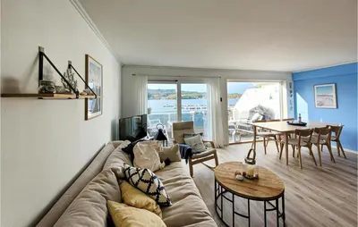 a living room with a couch and a table at Cozy Apartment In Uggdal With Wifi in Uggdal