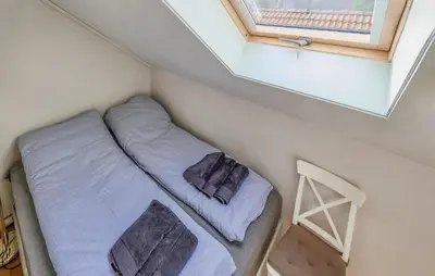 a small room with two beds and a window at Cozy Apartment In Uggdal With Wifi in Uggdal