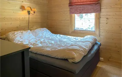 a bed in a room with a desk and a window at Gorgeous Home In Bjorli With Wifi in Bjorli