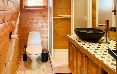 a bathroom with a toilet and a black sink at Gorgeous Home In Bjorli With Wifi in Bjorli