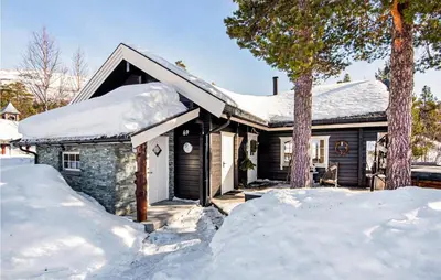 a house covered in snow with snow piled up at Gorgeous Home In Bjorli With Wifi in Bjorli