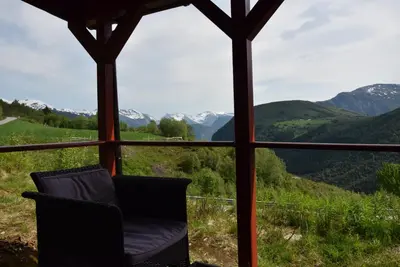 a room with a view of mountains through a window at Hesthaug Gard in Eidsdal