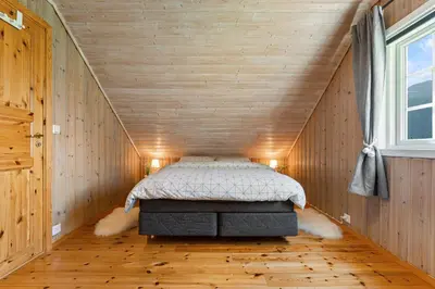 a bedroom with a bed in a small room at Hygge Hütte - zwischen Fjell und Fjord in Lauvstad