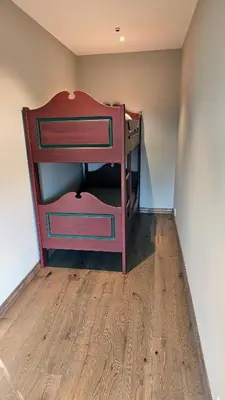 a wooden bunk bed in a room with a wooden floor at Huso Mountain Lodge - Hemsedal in Eikregardane