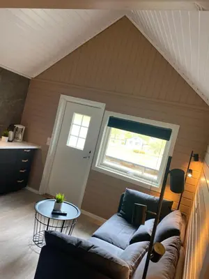 a living room with a couch and a table at Nygård Camping in Hjelle
