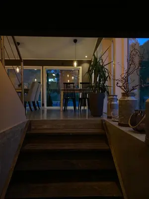 a staircase leading to a room with a table and chairs at Nygård Camping in Hjelle
