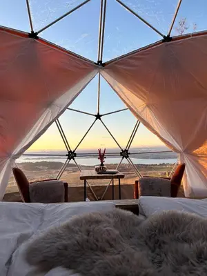 a room with a view of the ocean from a tent at Forbord Dome in Tilleraune