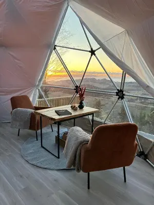 a table and chairs in a tent with a view at Forbord Dome in Tilleraune
