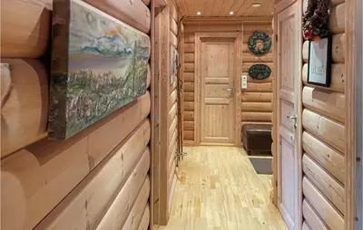 a hallway with wood paneling and a painting on the wall at Cozy Home In Østby With Wifi in Trysil
