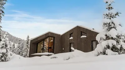 a house in the snow with snow covered trees at Ski-in-out hytte på Kvitfjell in Strande