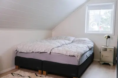 a bedroom with a bed in a room with a window at Beautiful Private Villa with Lake View and Boat in Hålland