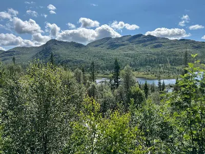 a view of a valley with a lake and mountains at Cabin with a great view at Gaustablikk in Gaustablikk