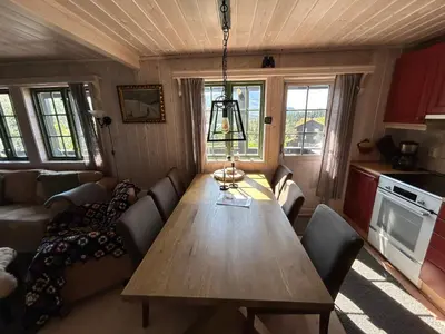 a living room with a wooden table and chairs at Cabin with a great view at Gaustablikk in Gaustablikk