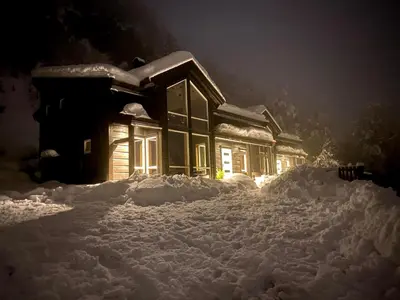 a house covered in snow at night at Moderne hytte i Svandalen, Sauda - nær skisenter og natur in Sauda