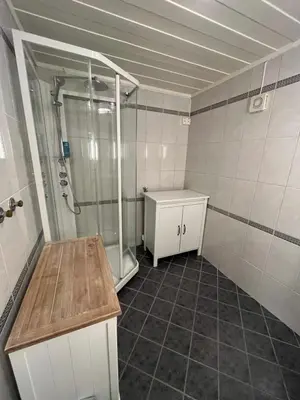 a bathroom with a shower and a sink at Koselig rom i rolige omgivelser in Rena