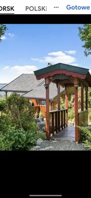 a wooden gazebo in front of a house at Domek Iwony in Molde