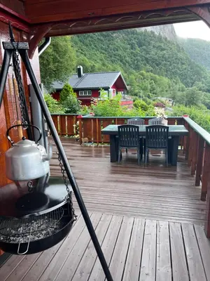 a deck with a table and chairs on a house at Domek Iwony in Molde