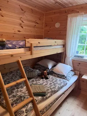 a bedroom with two bunk beds in a log cabin at Domek Iwony in Molde