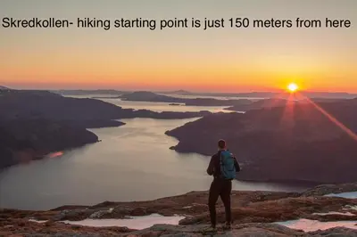 a man standing on top of a mountain watching the sunset at Apartment-B near Etne-Odda in Etnesjøen