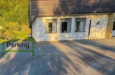 a house with a parking sign in front of it at Apartment-B near Etne-Odda in Etnesjøen
