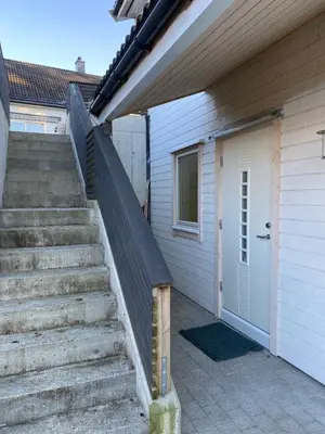 a set of stairs next to a house with a door at Your Dream Studio in Bergen in Bergen