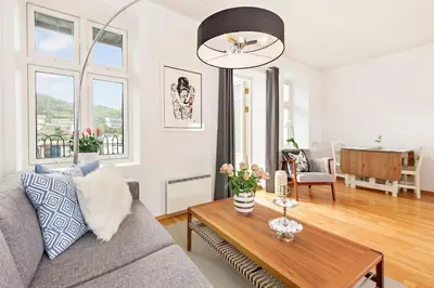 a living room with a couch and a table at Flott leilighet på Nygårdshøyden in Bergen