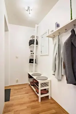 a walk in closet with white walls and wooden floors at Flott leilighet på Nygårdshøyden in Bergen