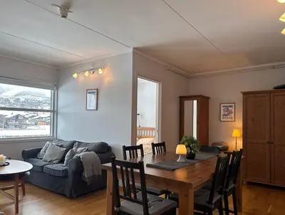 a living room with a table and a couch at Stay in the heart of Geilo, walk to everything in Geilo