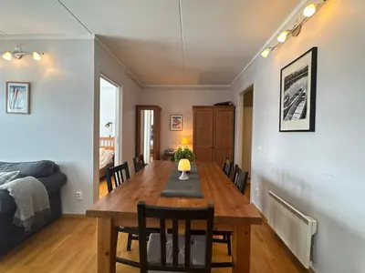 a dining room and living room with a table and chairs at Stay in the heart of Geilo, walk to everything in Geilo