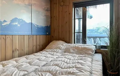 a large bed in a room with a large window at Awesome Home In Hornindal With Wifi in Hornindal
