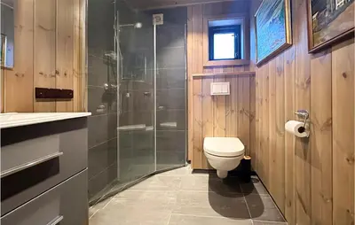 a bathroom with a toilet and a glass shower at Awesome Home In Hornindal With Wifi in Hornindal