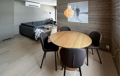 a living room with a table and chairs and a couch at 2 Bedroom Nice Apartment In Geilo in Geilo