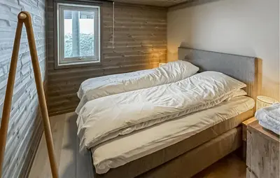 a bedroom with two beds and a window at 2 Bedroom Nice Apartment In Geilo in Geilo